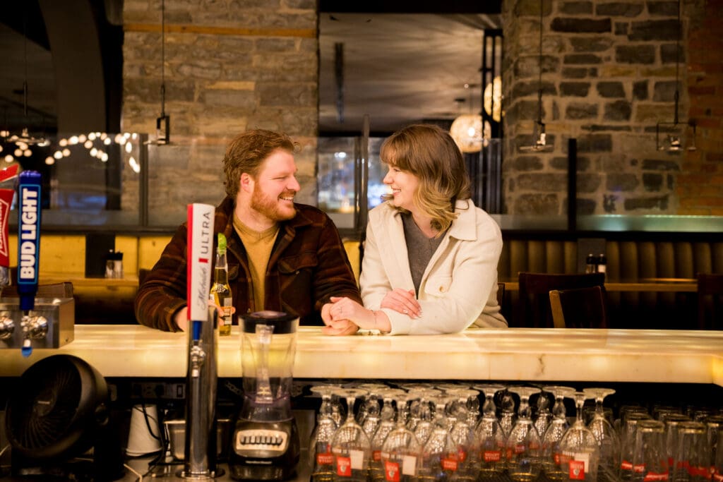 A couple looks at each other at the Milestone's bar in downtown Kingston