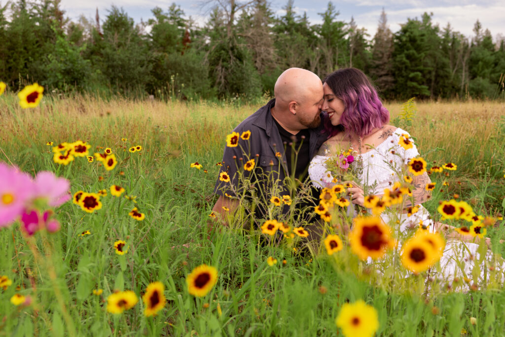 engaged couple in wildflower field